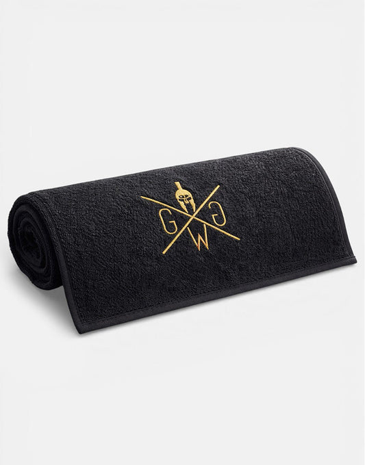 Kleines schwarzes Sporthandtuch mit goldenem Logo, aufgerollt
