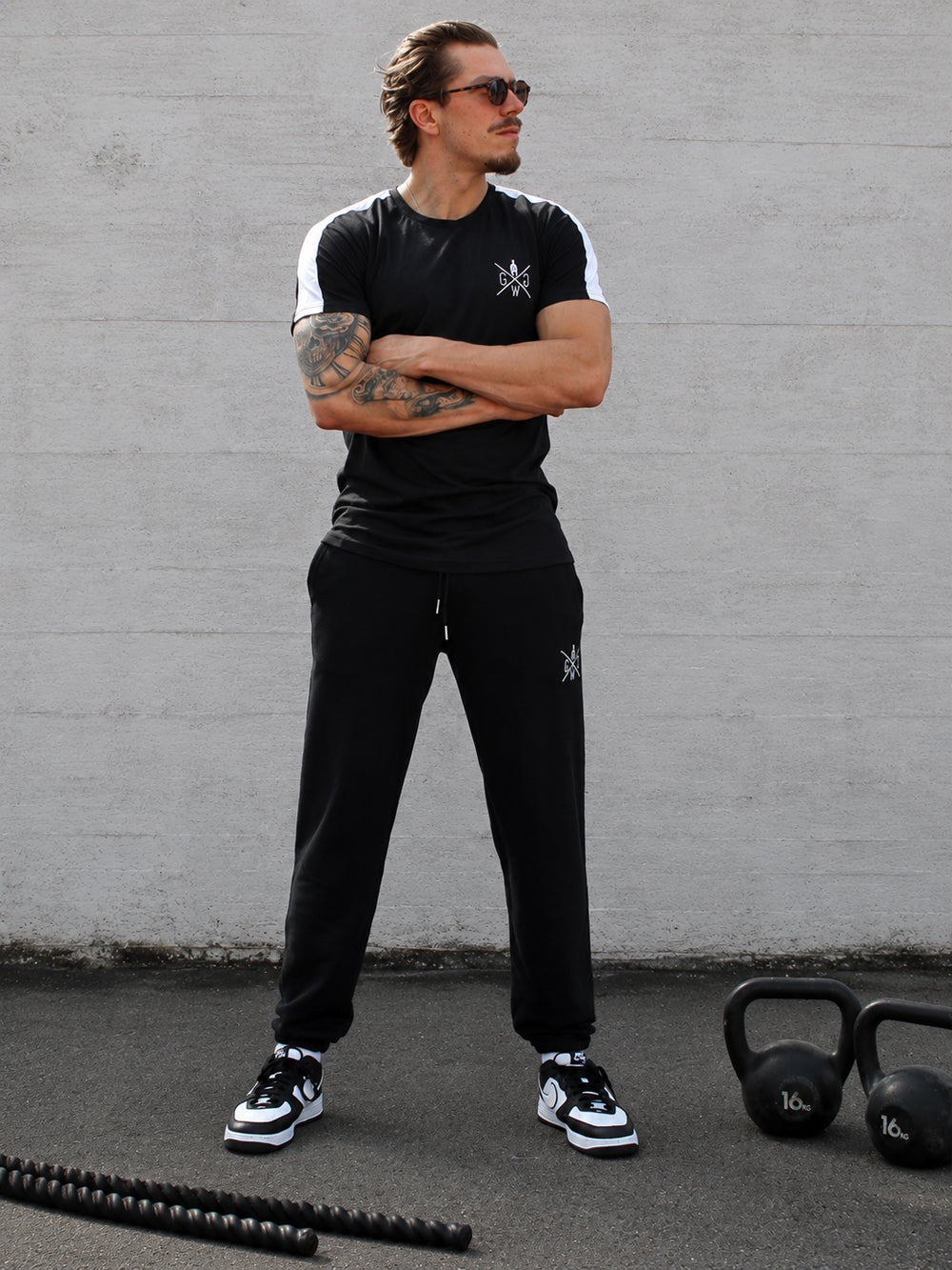 Model im schwarzen Gym Shirt mit Schulterstreifen